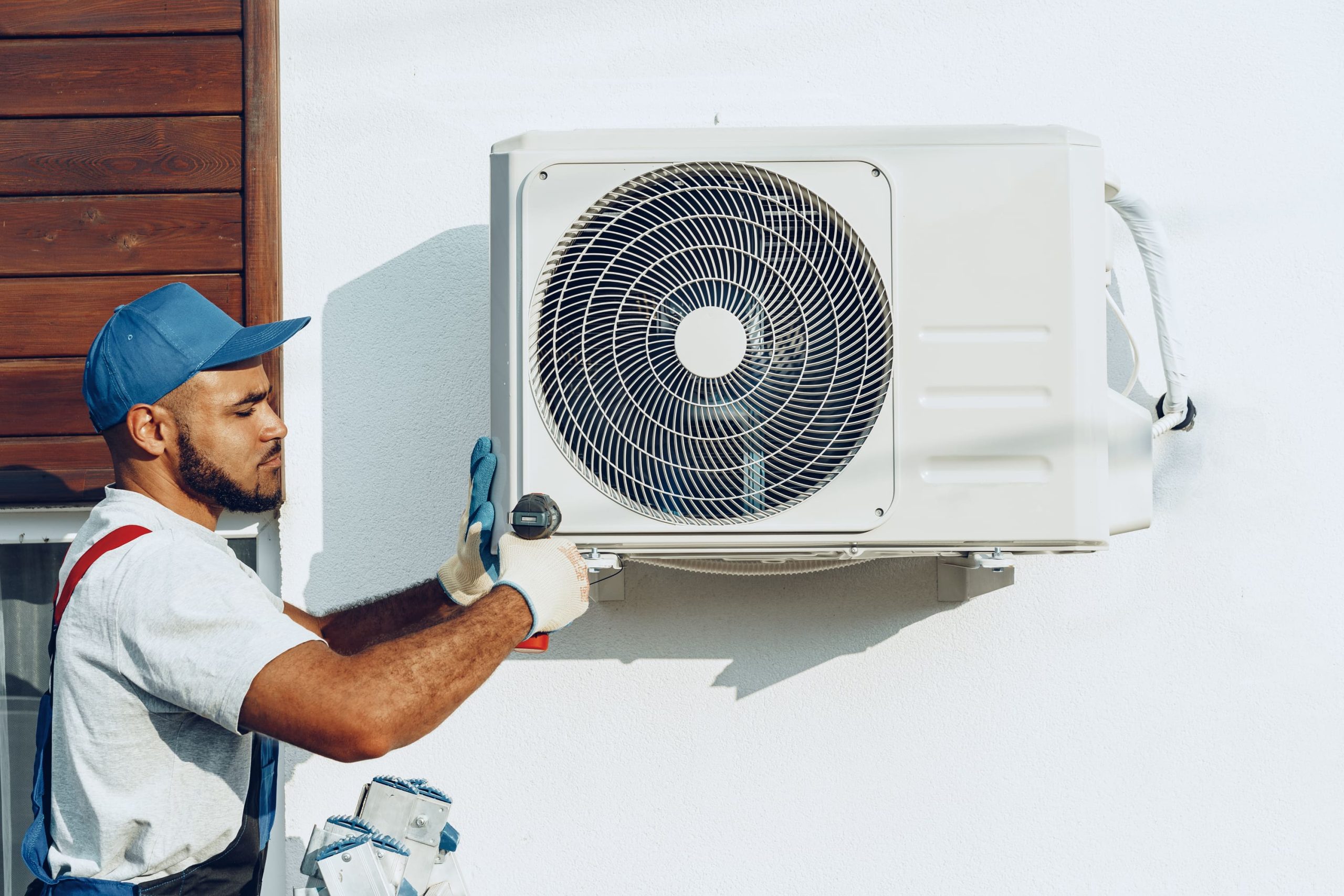 repairman-in-uniform-installing-the-outside-unit-o-2025-02-25-12-45-19-utc
