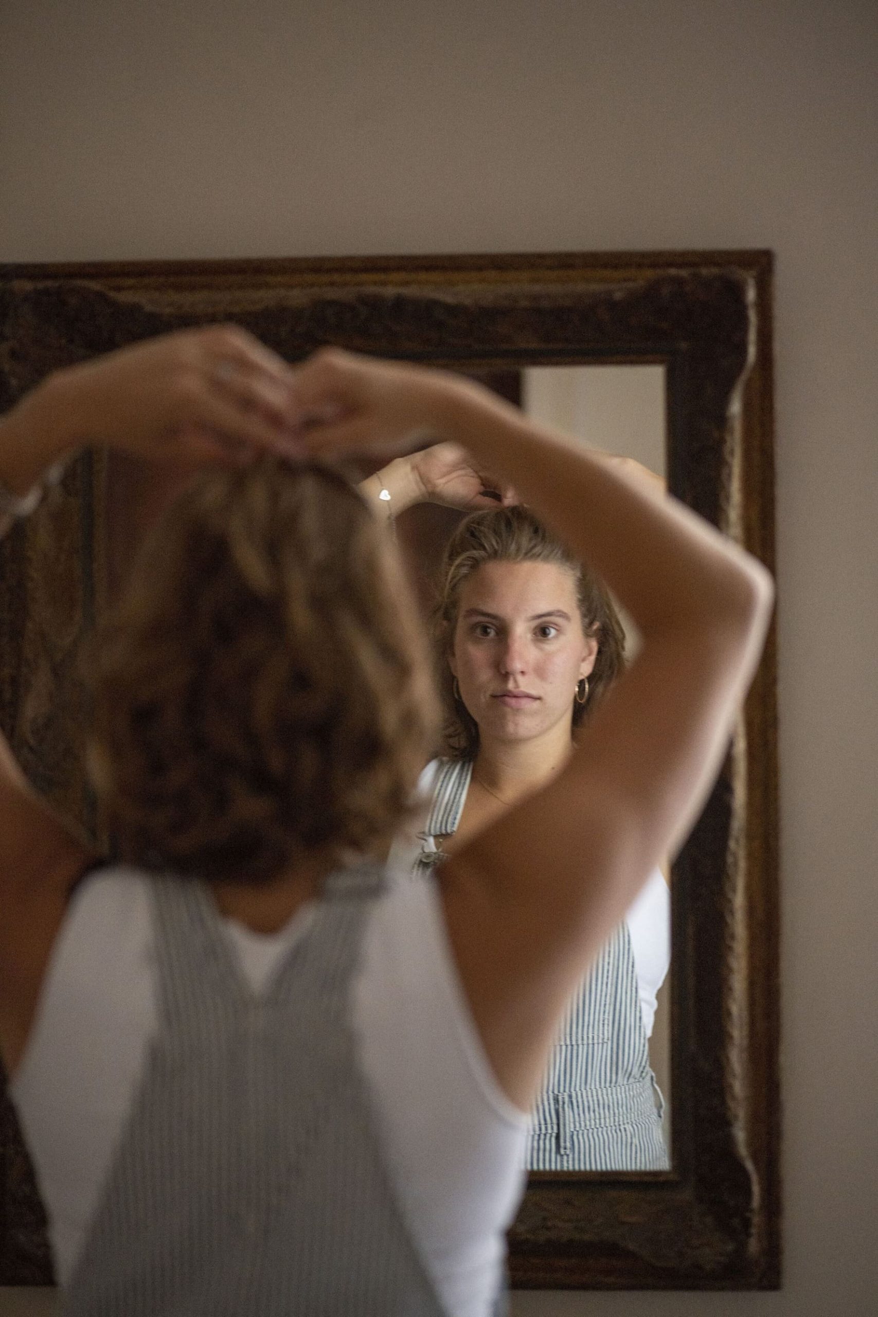 young-attractive-woman-putting-her-hair-up-in-a-bu-2025-04-03-12-56-55-utc (4)